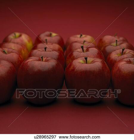Stock Photo - Apples arranged in square, red background. Fotosearch