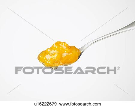 Stock Photo - Apricot jam on spoon, white background. Fotosearch