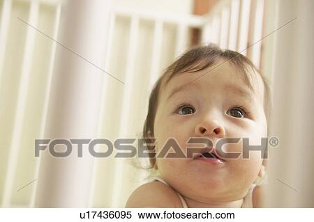 Stock Photography - Baby viewed through cot. Fotosearch