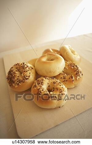 Bagels on cutting board View Large Photo Image Stock Photo - Bagels on cutting board. Fotosearch