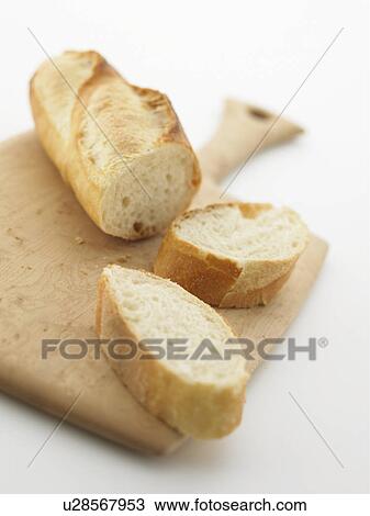 Stock Image - Baguette on cutting board. Fotosearch