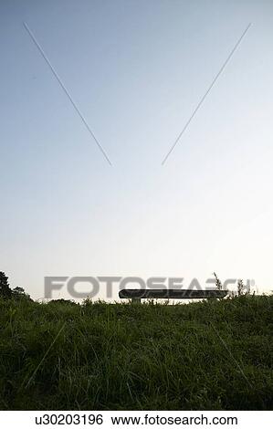 Stock Photograph - Bench in Green Field. Fotosearch