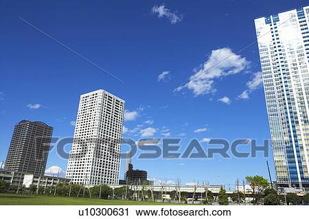 Stock Image - Blue sky over office buildings. Fotosearch