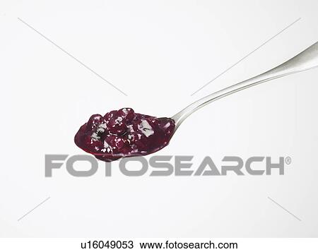 Stock Image - Blueberry jam on spoon, white background. Fotosearch