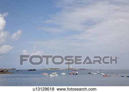 Boats on the Sea, Lighthouse in the Background, Vierge, Bretagne, France View Large Photo Image Stock Photo - Boats on the Sea, Lighthouse in the Background, Vierge, Bretagne, France. Fotosearch