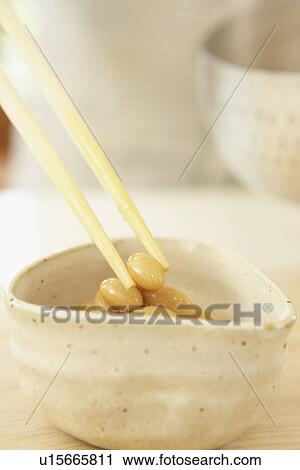 Stock Image - Bowl of fried soybeans, close up. Fotosearch