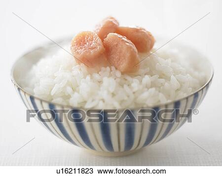 Stock Image - Bowl of rice with salted cod roe, close up, white background. Fotosearch