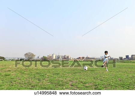 Boy kicking soccer ball View Large Photo Image Stock Photo - Boy kicking soccer ball. Fotosearch
