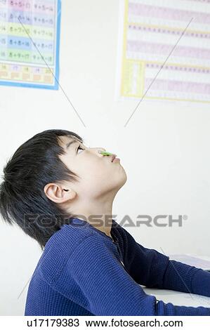 Stock Image - Boy looking up at cram school. Fotosearch