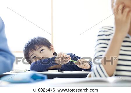 Boy thinking holding a pencil View Large Photo Image Stock Photograph - Boy thinking holding a pencil. Fotosearch