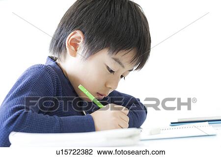 Boy writing on notebook at cram school View Large Photo Image Stock Image - Boy writing on notebook at cram school. Fotosearch