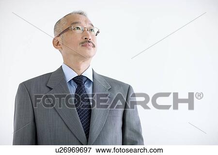 Stock Photo - Businessman looking away, white background. Fotosearch