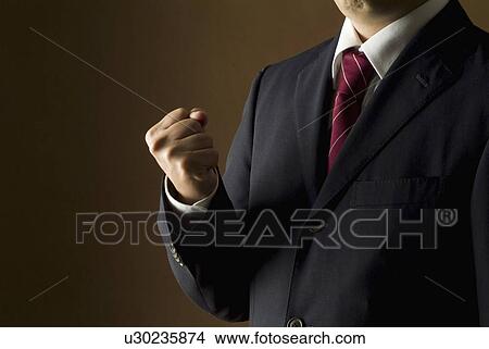 Businessman making a fist View Large Photo Image Picture - Businessman making a fist. Fotosearch