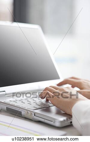 Stock Image - Businesswoman using laptop. Fotosearch