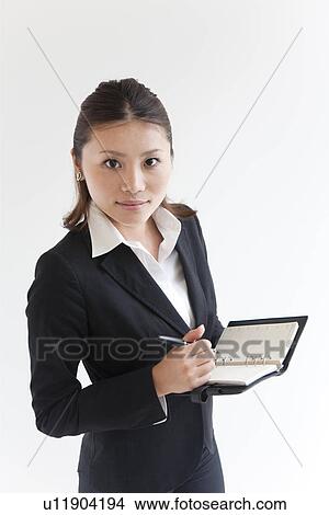 Picture - Businesswoman with a diary. Fotosearch