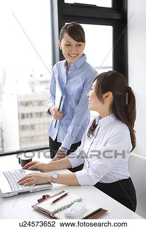 Stock Image - Businesswomen talking. Fotosearch