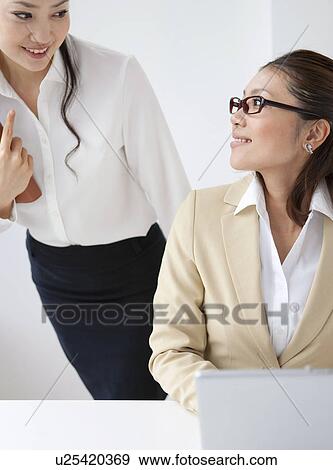 Stock Photo - Businesswomen talking. Fotosearch