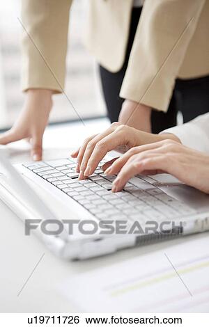 Stock Photograph - Businesswomen using laptop. Fotosearch