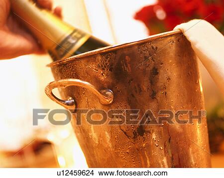 Champagne bottle in ice bucket, close up View Large Photo Image Picture - Champagne bottle in ice bucket, close up. Fotosearch