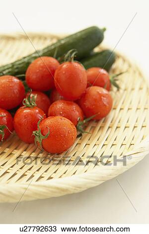 Cherry tomatoes and cucumbers on colander, close up, white background View Large Photo Image Stock Image - Cherry tomatoes and cucumbers on colander, close up, white background. Fotosearch