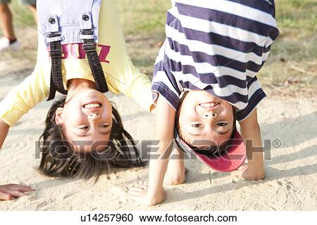 Children doing handstand View Large Photo Image Stock Image - Children doing handstand. Fotosearch