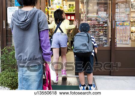 Children going into Dagashi-ya View Large Photo Image Stock Photo - Children going into Dagashi-ya. Fotosearch