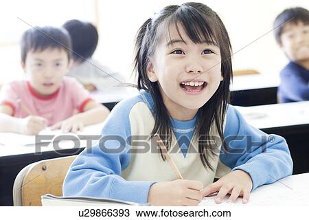 Stock Image - Children studying at cram school. Fotosearch
