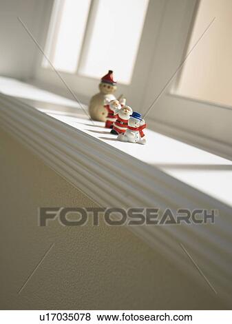 Stock Photo - Christmas ornaments on window sill. Fotosearch
