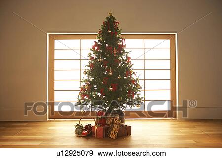 Stock Photo - Christmas presents under Christmas tree. Fotosearch