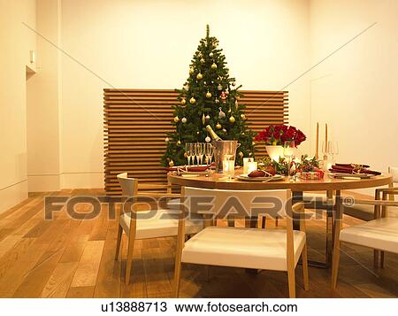 Stock Image - Christmas tree and table decorated for Christmas. Fotosearch