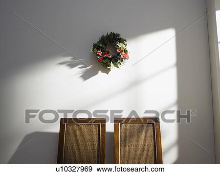 Christmas wreath on wall View Large Photo Image Stock Photo - Christmas wreath on wall. Fotosearch