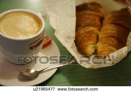 Stock Photo - Close Up of Cup of Coffee and Croissant. Fotosearch