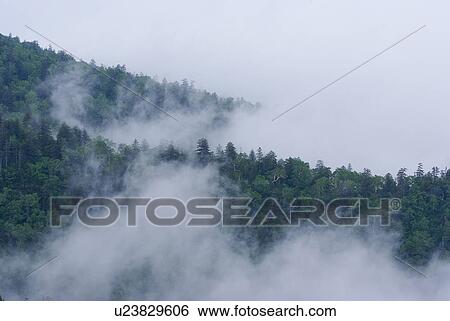 Stock Photograph - Clouds covering Mt. Tokachidake. Fotosearch