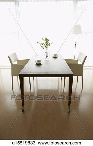 Stock Image - Coffee cups on dining table. Fotosearch