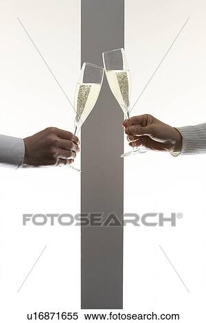 Couple toasting with glass of champagne, white background View Large Photo Image Stock Photography - Couple toasting with glass of champagne, white background. Fotosearch