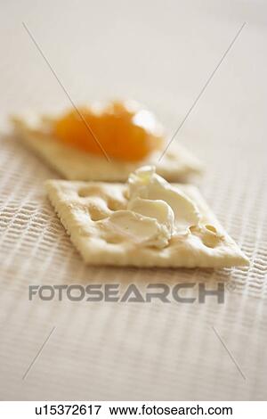 Crackers with cream cheese and jam, close up, differential focus View Large Photo Image Stock Photo - Crackers with cream cheese and jam, close up, differential focus. Fotosearch