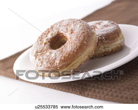Stock Photography - Doughnuts on plate, close up, white background. Fotosearch