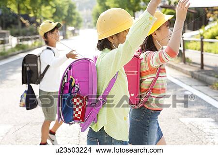 Elementary school students crossing the street View Large Photo Image Picture - Elementary school students crossing the street. Fotosearch