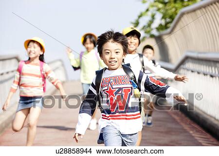 Picture - Elementary school students running to school. Fotosearch