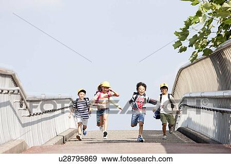 Elementary school students running to school View Large Photo Image Stock Photo - Elementary school students running to school. Fotosearch