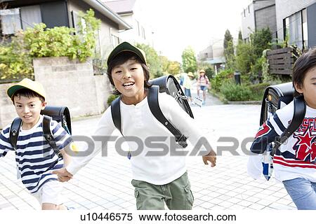 Elementary school students running to school View Large Photo Image Stock Photography - Elementary school students running to school. Fotosearch