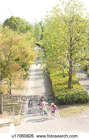 Elementary school students walking to school, high angle view View Large Photo Image Stock Photograph - Elementary school students walking to school, high angle view. Fotosearch