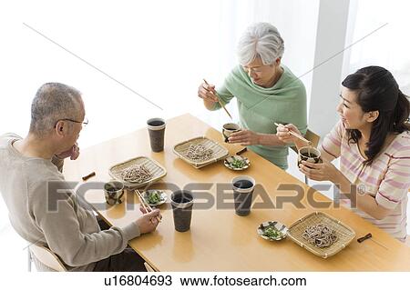 Family eating soba noodles, smiling View Large Photo Image Stock Image - Family eating soba noodles, smiling. Fotosearch