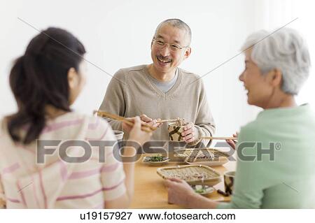 Family eating soba noodles, smiling View Large Photo Image Stock Photo - Family eating soba noodles, smiling. Fotosearch