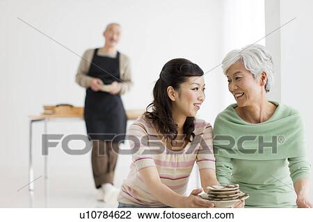 Family in dining room, differential focus View Large Photo Image Stock Image - Family in dining room, differential focus. Fotosearch