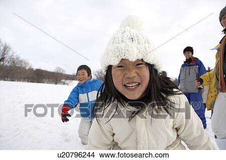 Picture - Family playing in snow. Fotosearch