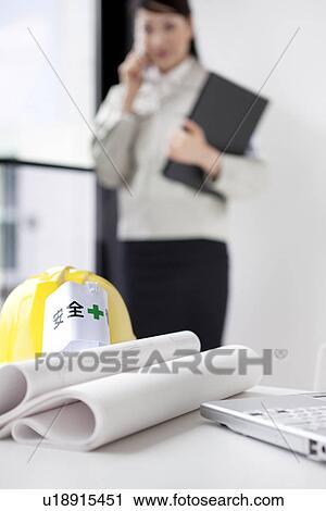 Stock Image - Female architect on a cell phone. Fotosearch