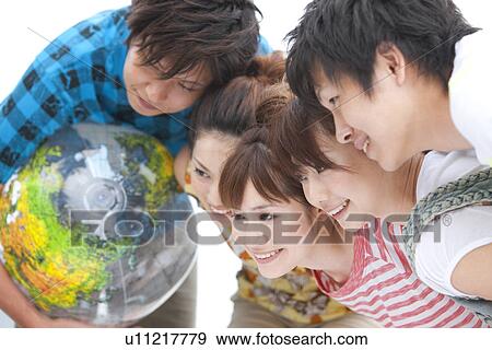 Five young people in huddle, smiling View Large Photo Image Stock Photo - Five young people in huddle, smiling. Fotosearch