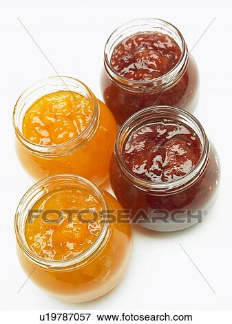 Stock Photo - Four jars of jam, close up, white background. Fotosearch