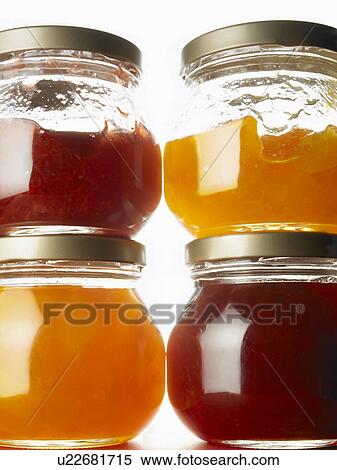 Stock Photography - Four jars of jam, close up, white background. Fotosearch